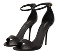 Sandales à talons dolce & gabbana en cuir noir avec brides cheville et boucles dorées style autruche