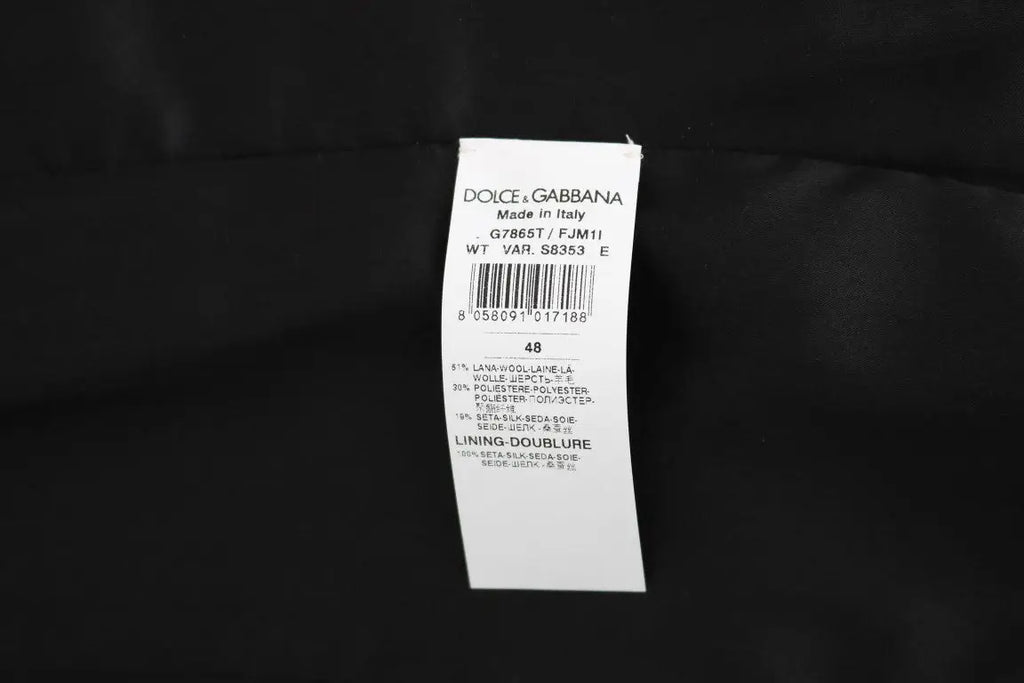 Étiquette blanche dolce & gabbana avec texte noir et barcode indiquant gilet noir à pois fabriqué en italie