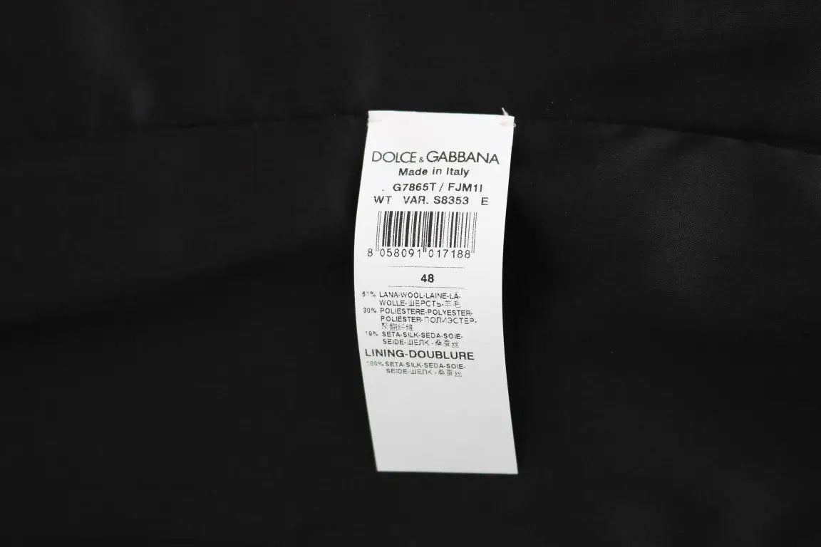 Étiquette blanche dolce & gabbana avec texte noir et barcode indiquant gilet noir à pois fabriqué en italie