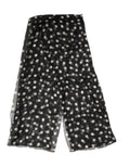 Jupe portefeuille en mousseline noire à pois blancs avec tissu transparent et fluide dolce gabbana