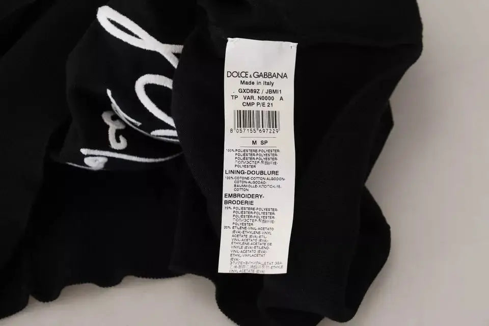 Étiquette noire dolce & gabbana avec lettrage blanc et code-barres pour pull homme en polyester noir col rond
