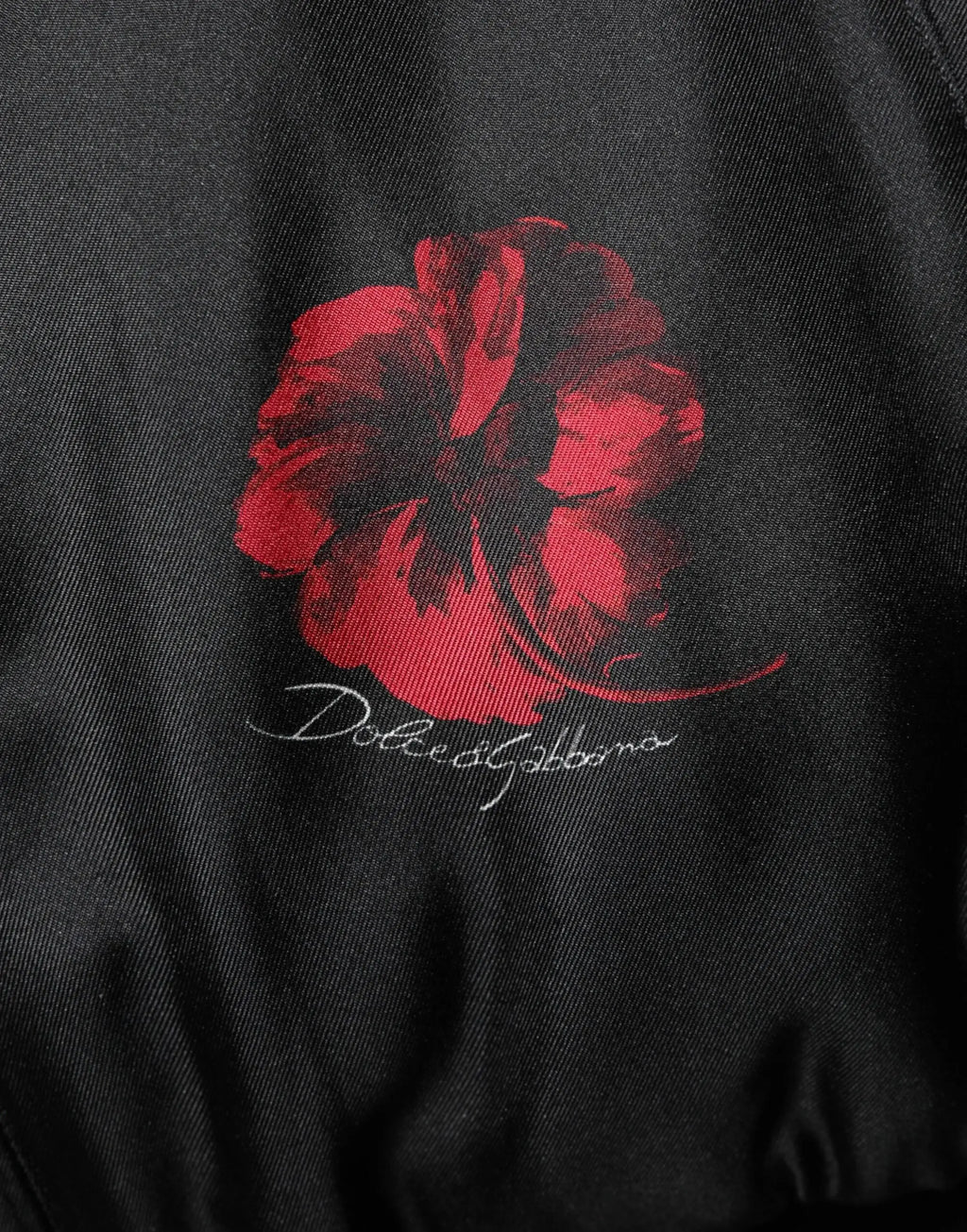 Veste bomber en soie noire dolce gabbana avec motif floral coquelicot rouge et signature blanche au dos