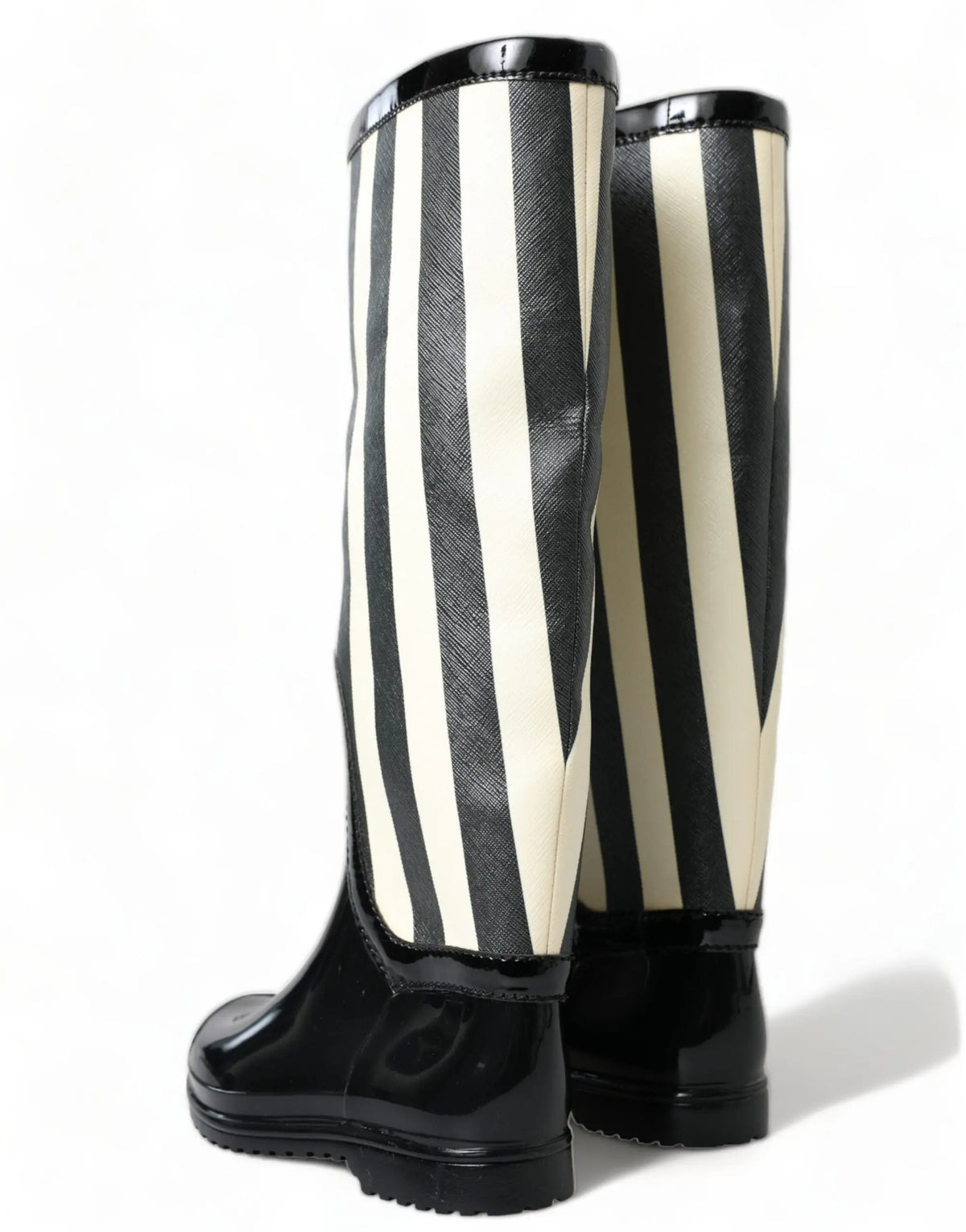 Dolce & Gabbana bottes plates en caoutchouc noires et crème à rayures verticales avec accents en cuir verni