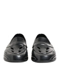 Dolce & gabbana chaussures noires slip-on brillantes en caoutchouc avec texture carbone et découpes smiley
