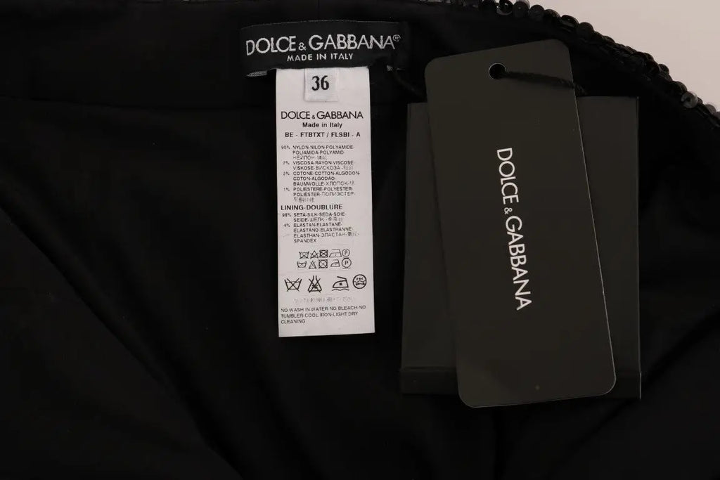 Étiquette noire dolce & gabbana avec label blanc et étiquette grise indiquant taille 36 et composition tissu pour shorts noirs à sequins