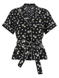 Dolce & Gabbana blouse en soie noire à manches courtes avec motif floral blanc et passepoil contrastant blanc
