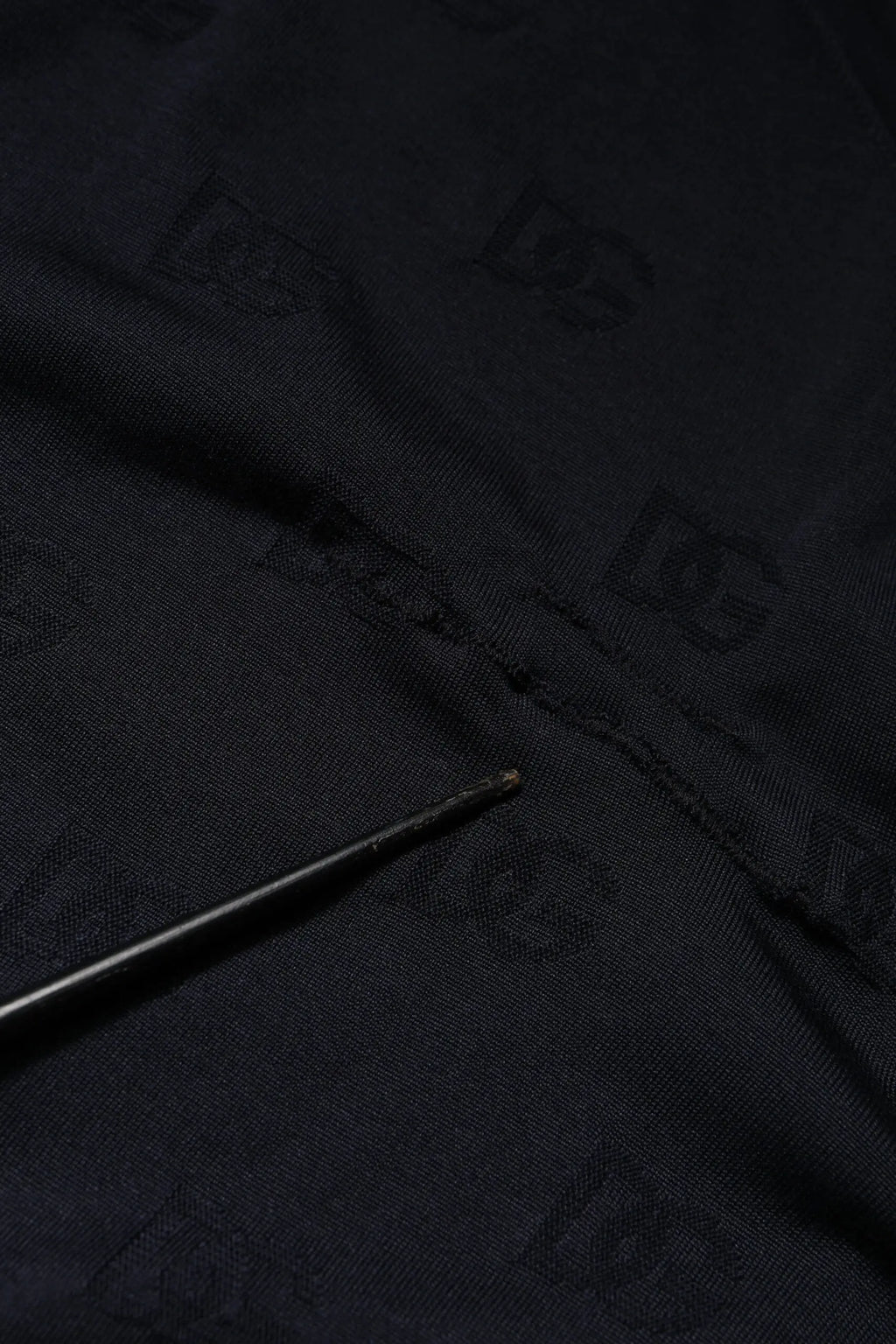 Black fabric with subtle repeating dg logo pattern on dolce gabbana black silk crew neck sweatshirt sweater