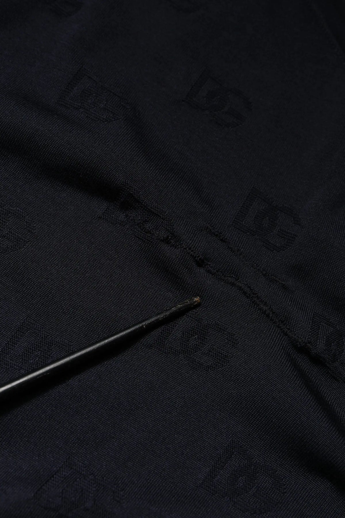 Black fabric with subtle repeating dg logo pattern on dolce gabbana black silk crew neck sweatshirt sweater