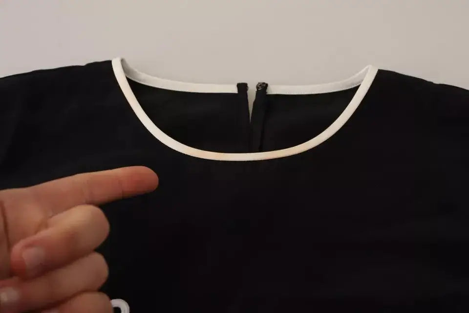 Dolce & Gabbana débardeur en soie noire éléganza avec col blanc à bordure et fermeture éclair centrale