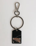 Dolce & gabbana porte-clés en marbre noir avec plaque en laiton embossée et anneau en métal argenté