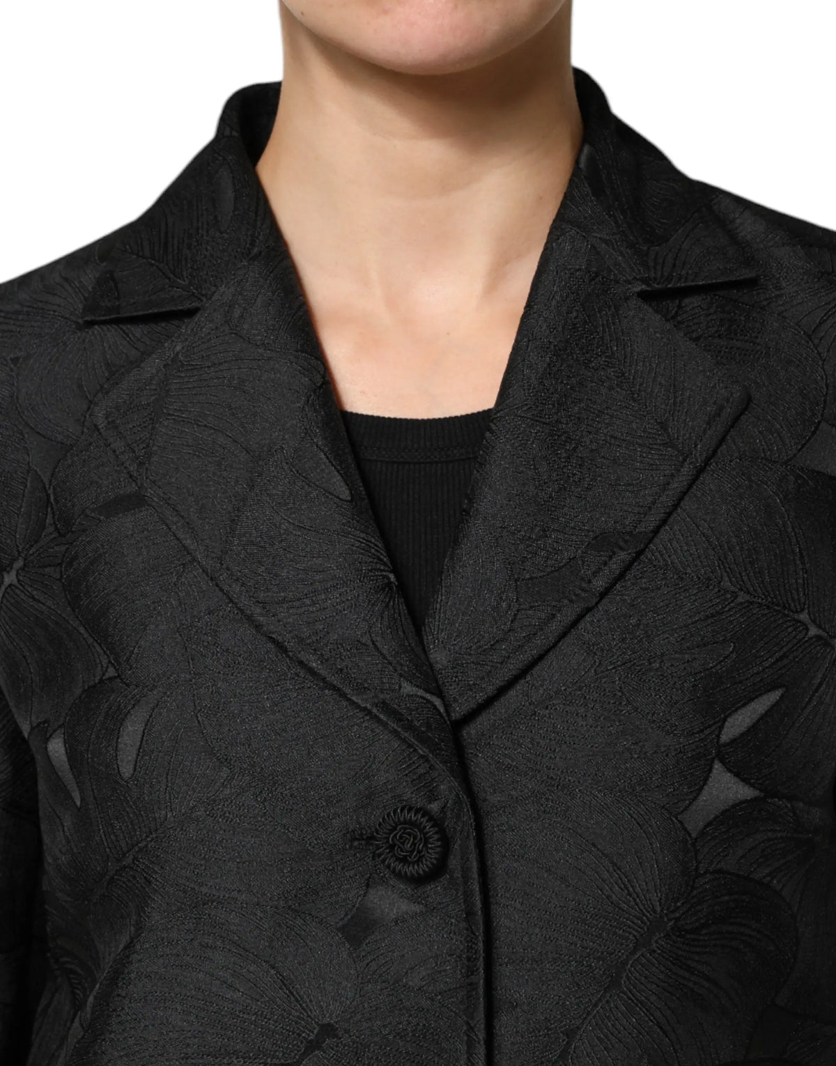 Dolce & gabbana veste trench noire simple boutonnage en tissu texturé avec motif feuille discret et col revers cranté