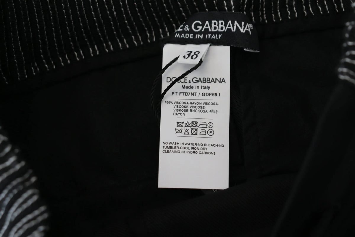 Étiquette noire dolce & gabbana avec taille 38 et détails tissu sur pantalon droit en coton noir