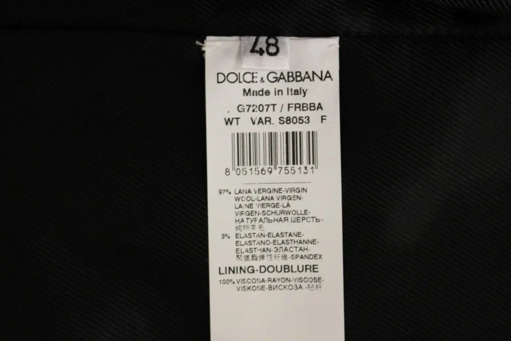 Étiquette dolce & gabbana blanche avec texte noir indiquant la composition en laine du gilet rayé noir