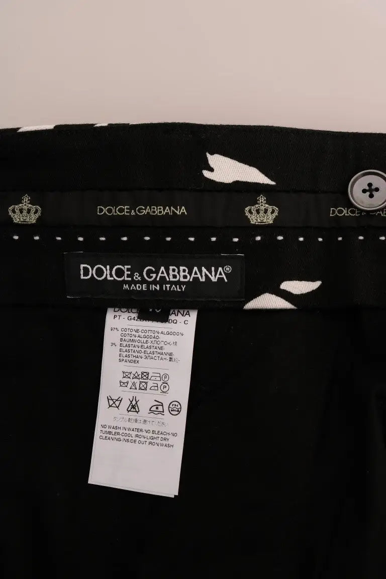 Pantalon dolce & gabbana noir en coton stretch avec broderie blanche d’oiseau et couronne