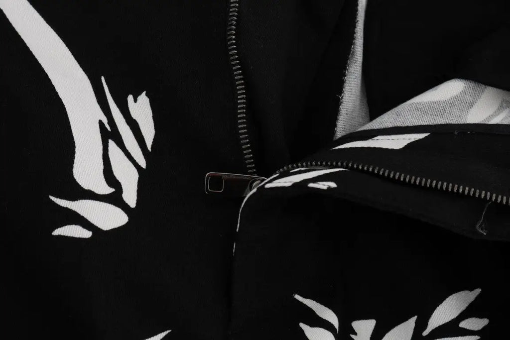 Veste noire dolce & gabbana avec motifs feuille abstraits blancs et fermeture éclair argentée