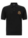 Polo en laine vierge noire dolce & gabbana avec écusson brodé doré sur la poitrine gauche
