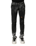 Dolce & Gabbana jean denim skinny noir délavé avec déchirures et détails cloutés le long des coutures extérieures