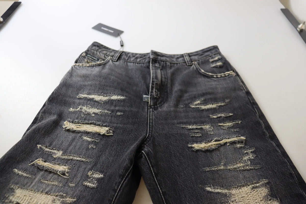Jean denim noir délavé dolce & gabbana taille haute avec déchirures multiples et bords effilochés
