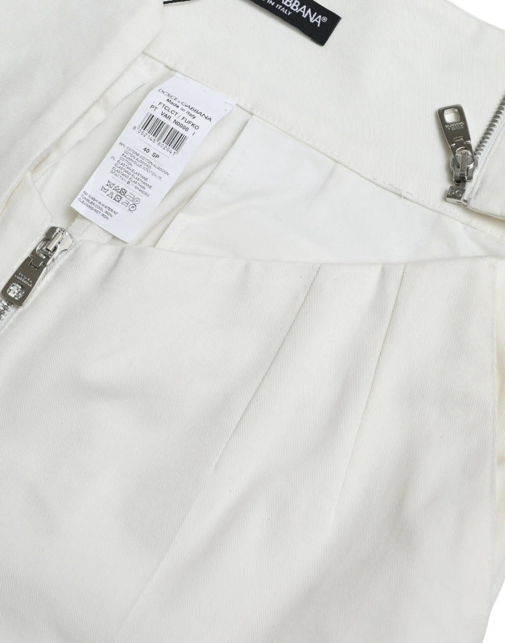 Pantalon tapered en coton noir et blanc dolce gabbana avec taille découpée et pantalon crème taille haute avec zips argentés
