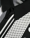 Polo en maille dolce & gabbana noir et blanc avec col noir uni, motifs géométriques et rayures verticales épaisses