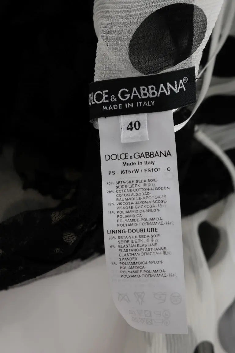 Étiquette dolce & gabbana sur robe noire à pois blancs et motifs floraux en 50 pour cent soie 24 pour cent coton made in italy