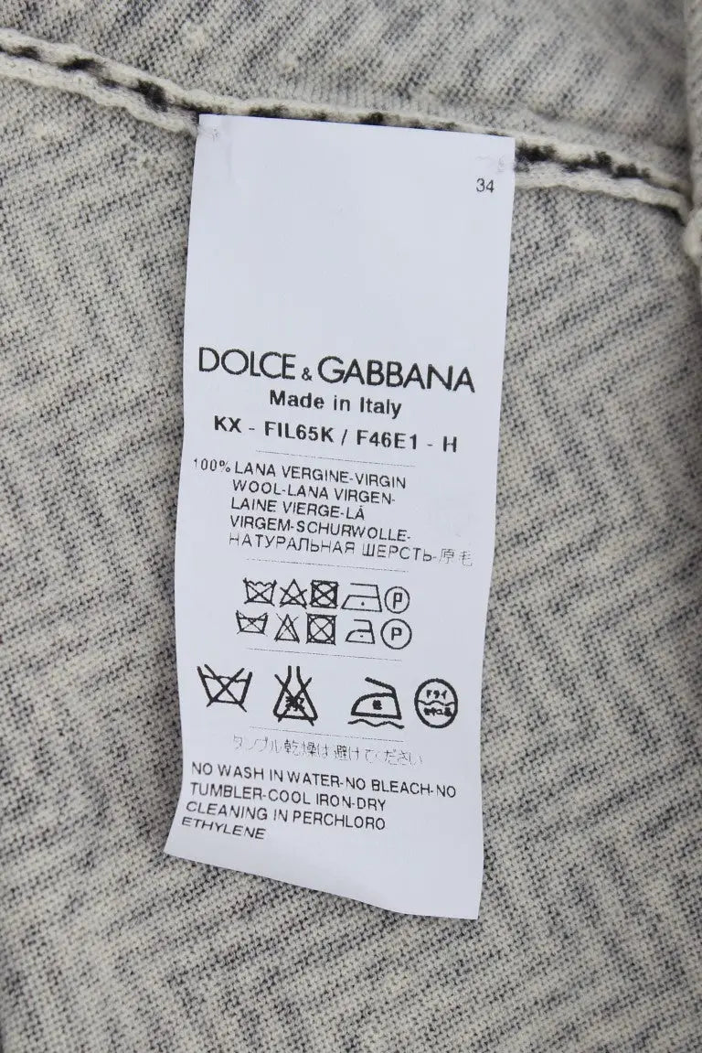 Étiquette de soin rectangulaire blanche avec texte et symboles noirs du cardigan en laine noir et blanc dolce & gabbana