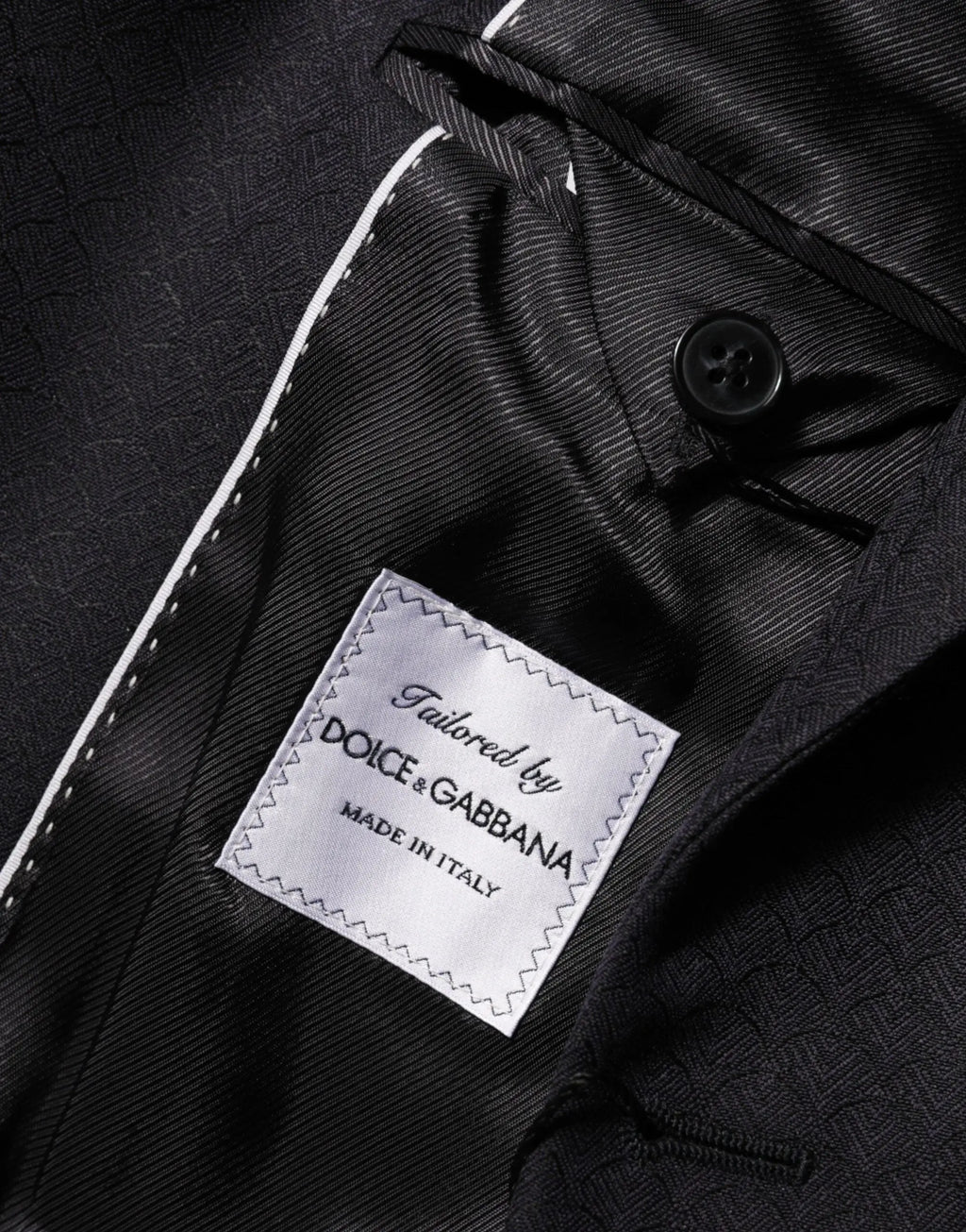 Veste de costume noire dolce gabbana en laine avec boutonnière blanche et étiquette argentée made in italy