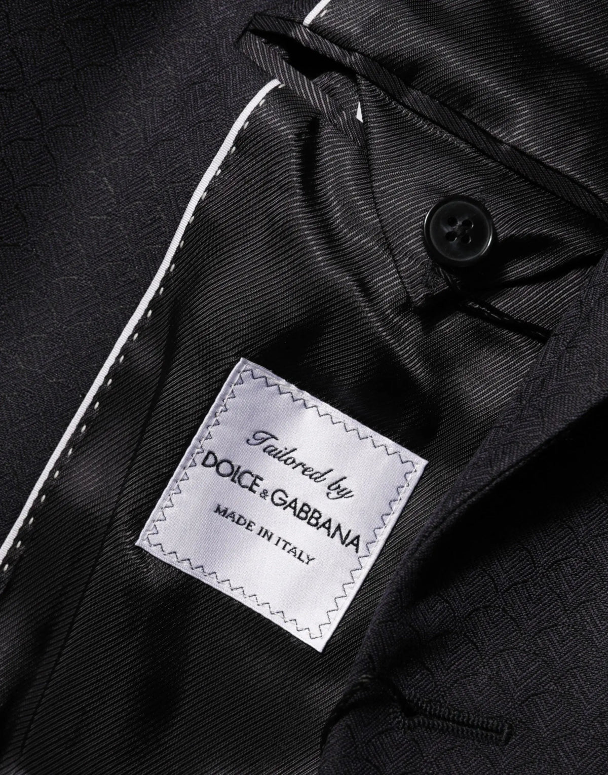 Veste de costume noire dolce gabbana en laine avec boutonnière blanche et étiquette argentée made in italy