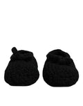 Petits chaussons bébé noirs en laine douce avec un motif texturé et un nœud confortable sur le dessus dolce & gabbana