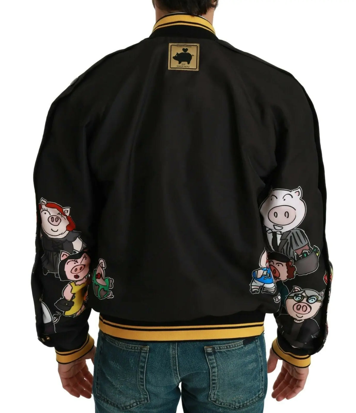 Dolce & gabbana bomber noir avec bordure jaune et patchs cartoon cochon sur les manches