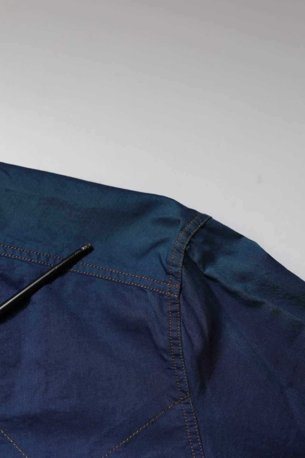 Veste en jean bleu foncé avec couture visible et un stylo noir posé sur l’épaule pour la chemise casual dolce & gabbana en coton bleu à manches longues gold