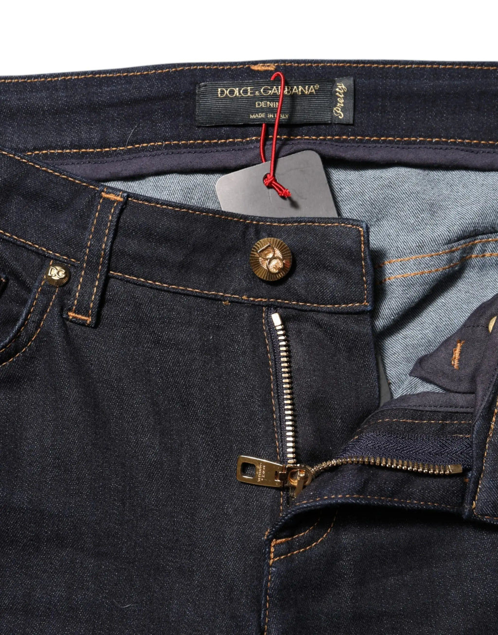 Jean skinny taille basse bleu en coton dolce & gabbana avec bouton tête de mort doré et fermeture éclair assortie