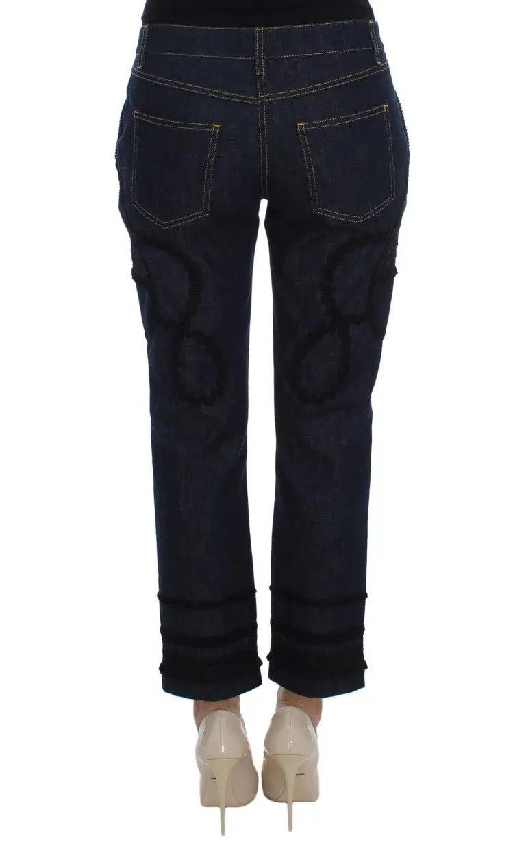 Jeans capri torero en denim bleu dolce gabbana en coton avec symboles infinis noirs brodés au dos et revers roulés
