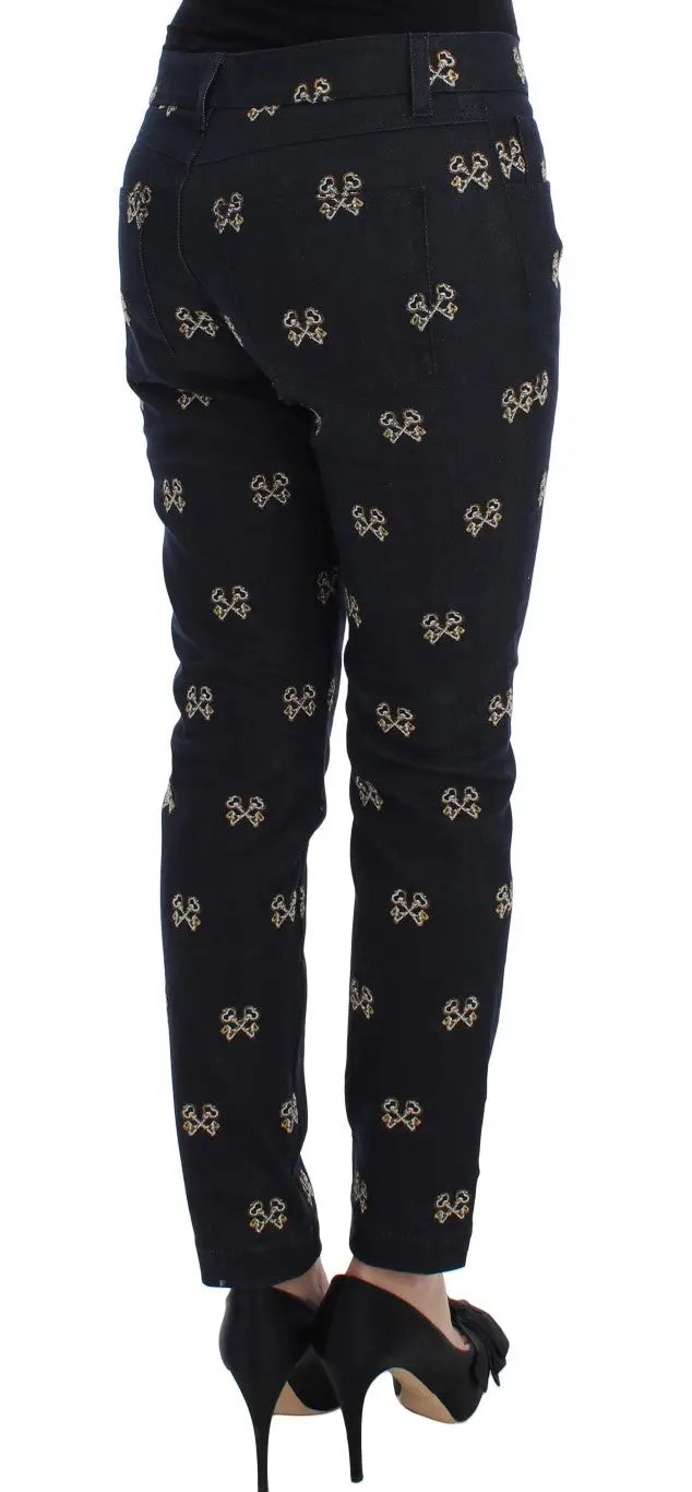 Trousers noirs dolce & gabbana avec un motif répété de petits nœuds dorés métalliques slim fit kate jean