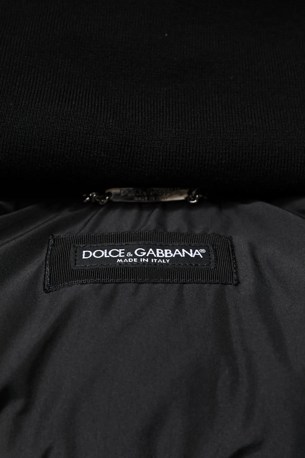Étiquette noire dolce & gabbana brodée blanche faite en italie sur tissu intérieur texturé de la veste matelassée à capuche bleu logo pleine fermeture éclair