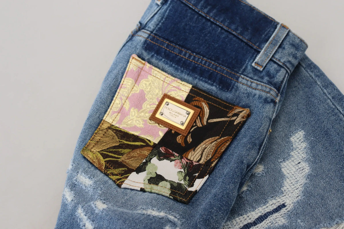 Vue arrière des jeans skinny en denim bleu dolce & gabbana en coton avec poche patchwork floral et plaque cuir marron
