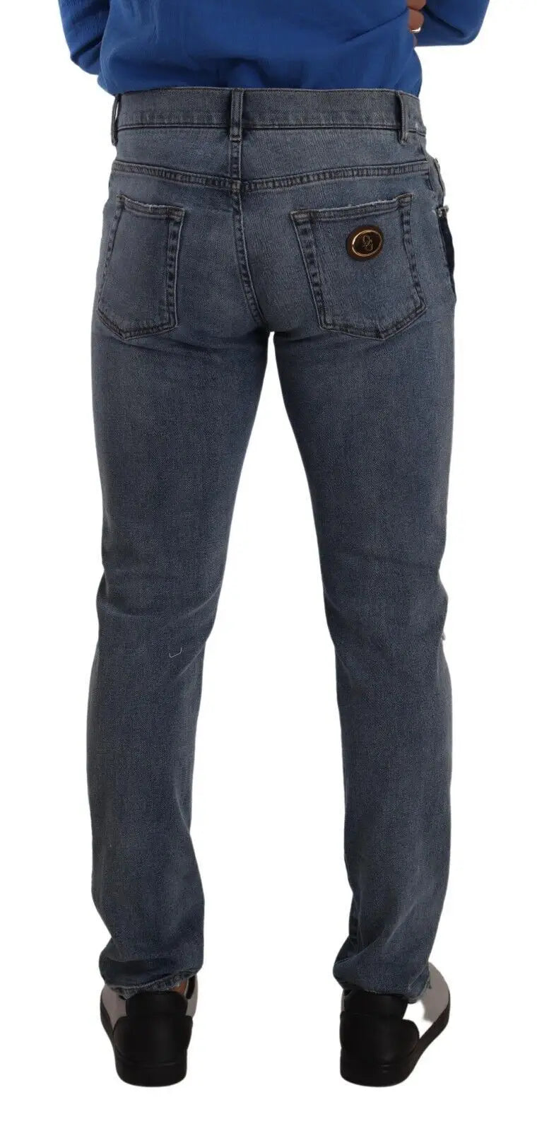 Jean denim slim bleu deux tons de dolce gabbana en coton avec poche arrière droite ornée d’un logo circulaire doré