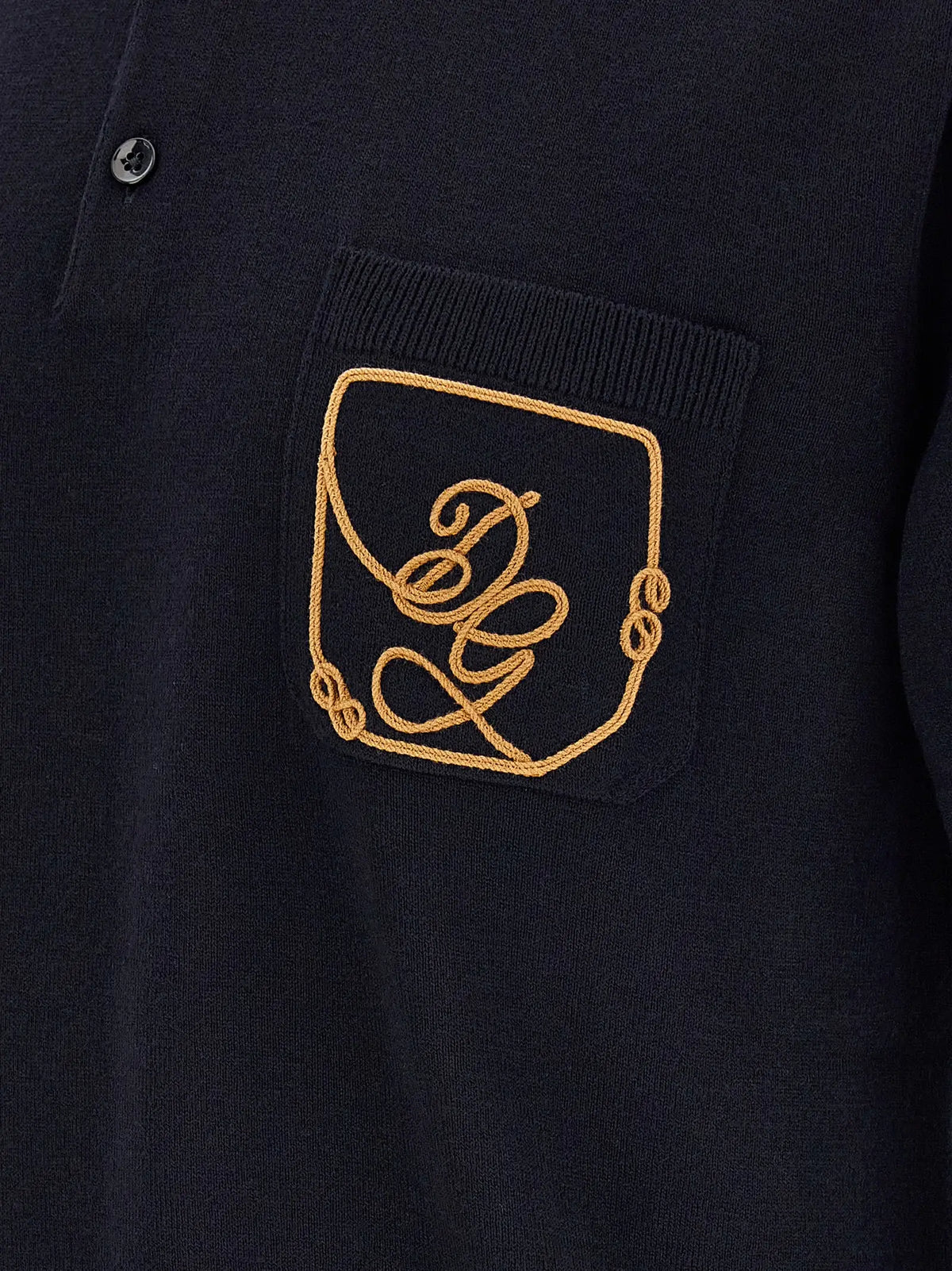 Polo bleu en laine vierge dolce & gabbana avec logo brodé en or sur la poche poitrine en maille marine foncée