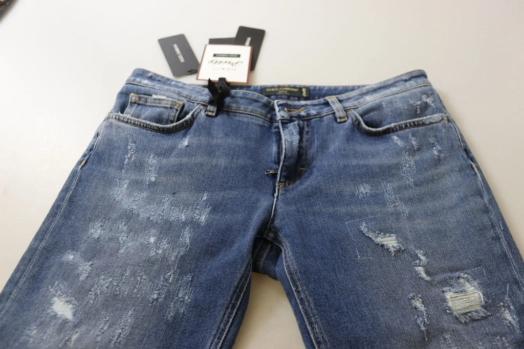Jean slim bleu délavé en coton dolce & gabbana avec détails déchirés et étiquette noire visible