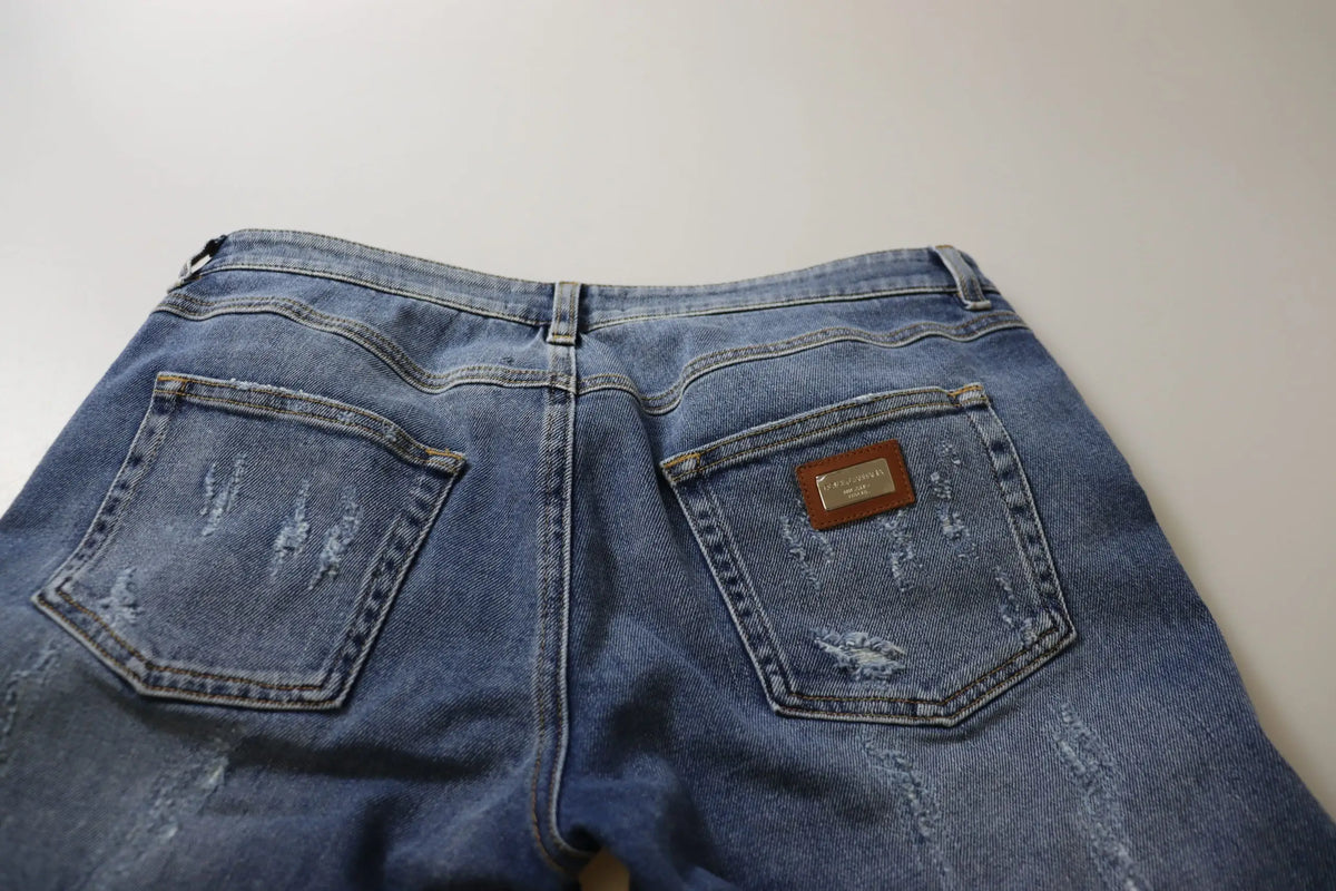 Vue arrière d un jean slim taille basse en coton bleu délavé avec patch cuir marron dolce & gabbana
