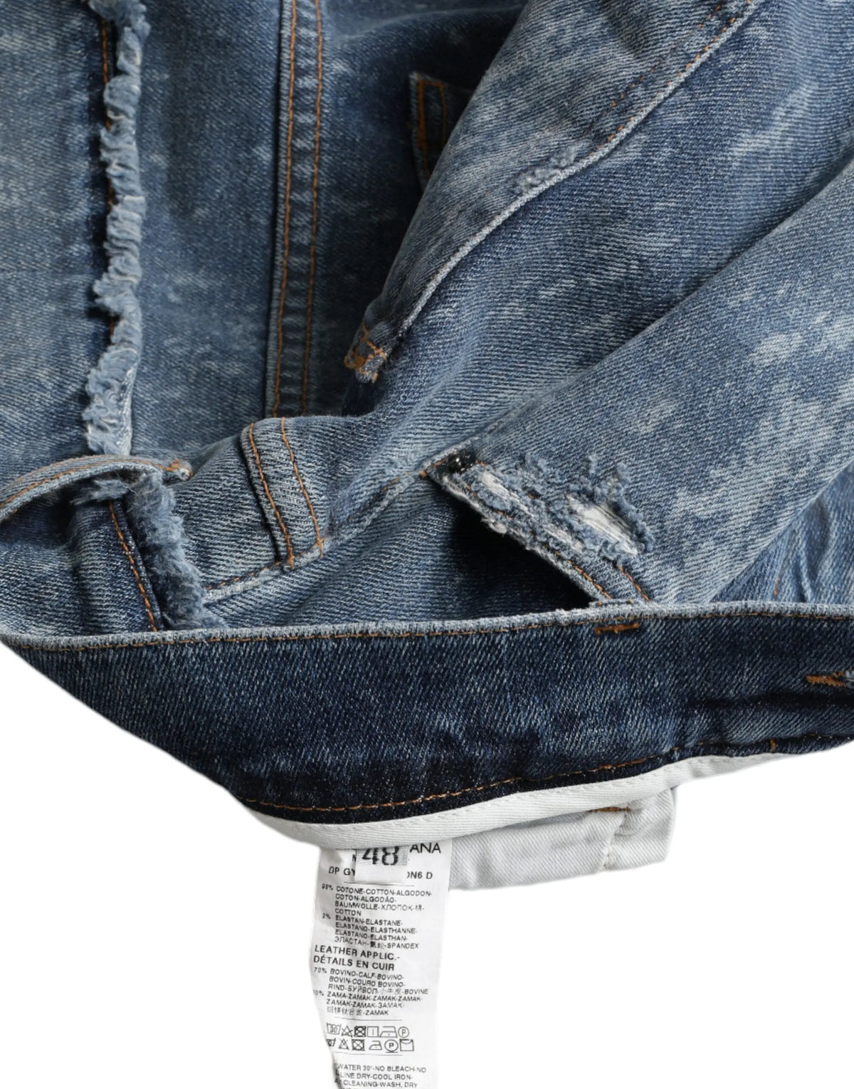 Jean skinny bleu délavé dolce & gabbana en denim stretch coton avec bords effilochés et étiquette de marque visible