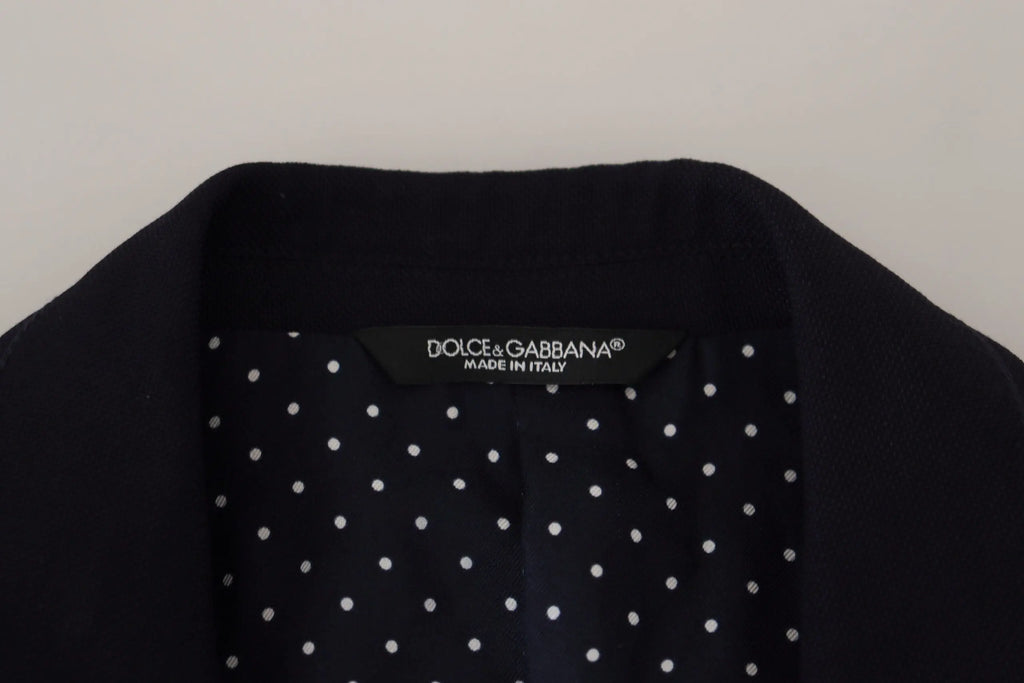 Manteau noir dolce & gabbana à pois blancs porté avec un blazer formel bleu en laine taormina