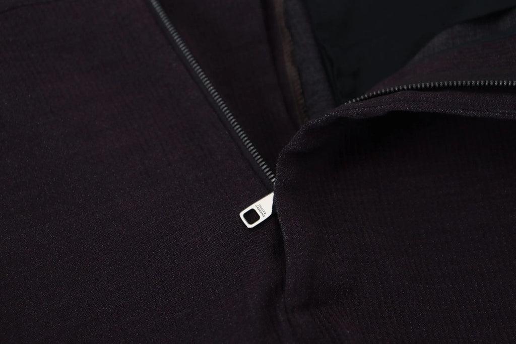 Black zipper pull with metallic finish on dark fabric jacket paired with dolce & gabbana brown cotton chino pants