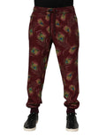 Dolce & gabbana pantalon jogger bordeaux en molleton avec imprimé vif de plumes de paon sur le tissu