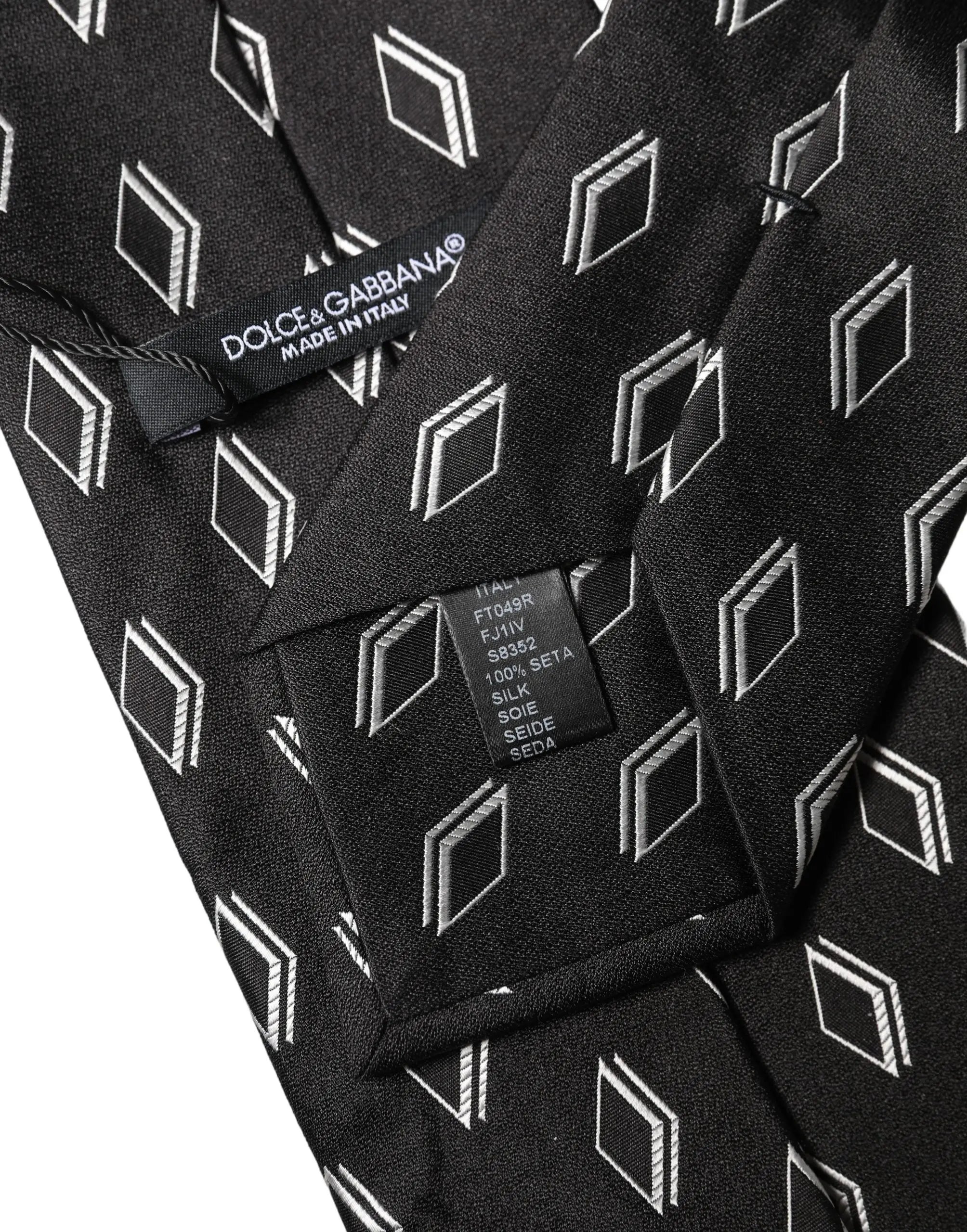 Cravate noire dolce & gabbana en soie avec motif répété de diamants géométriques blancs et lignes diagonales subtiles