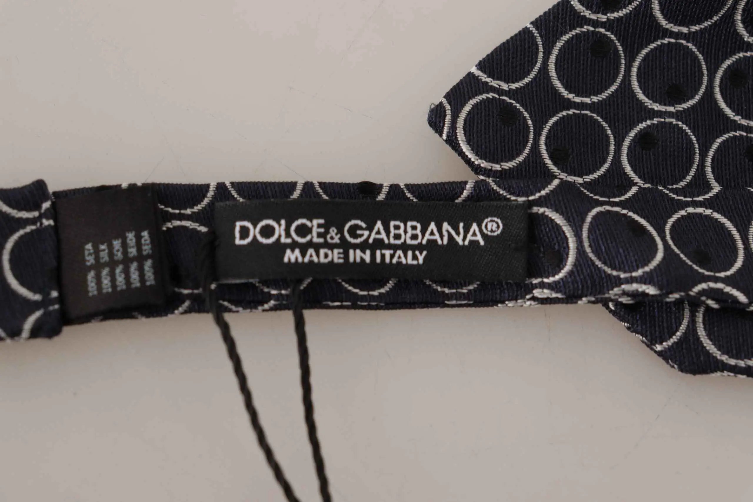 Cravate dolce & gabbana en soie 100 pour cent gris foncé avec motif de cercles concentriques blancs