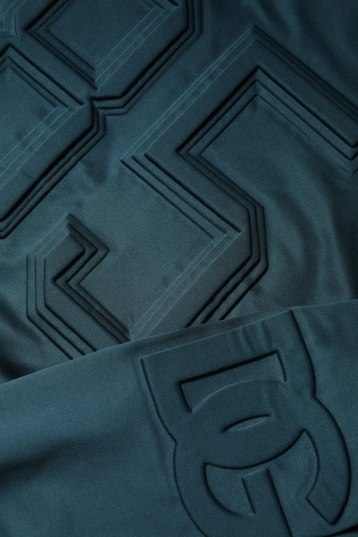 Pull-over dolce & gabbana vert foncé en tissu embossé avec motifs géométriques et patch logo visible