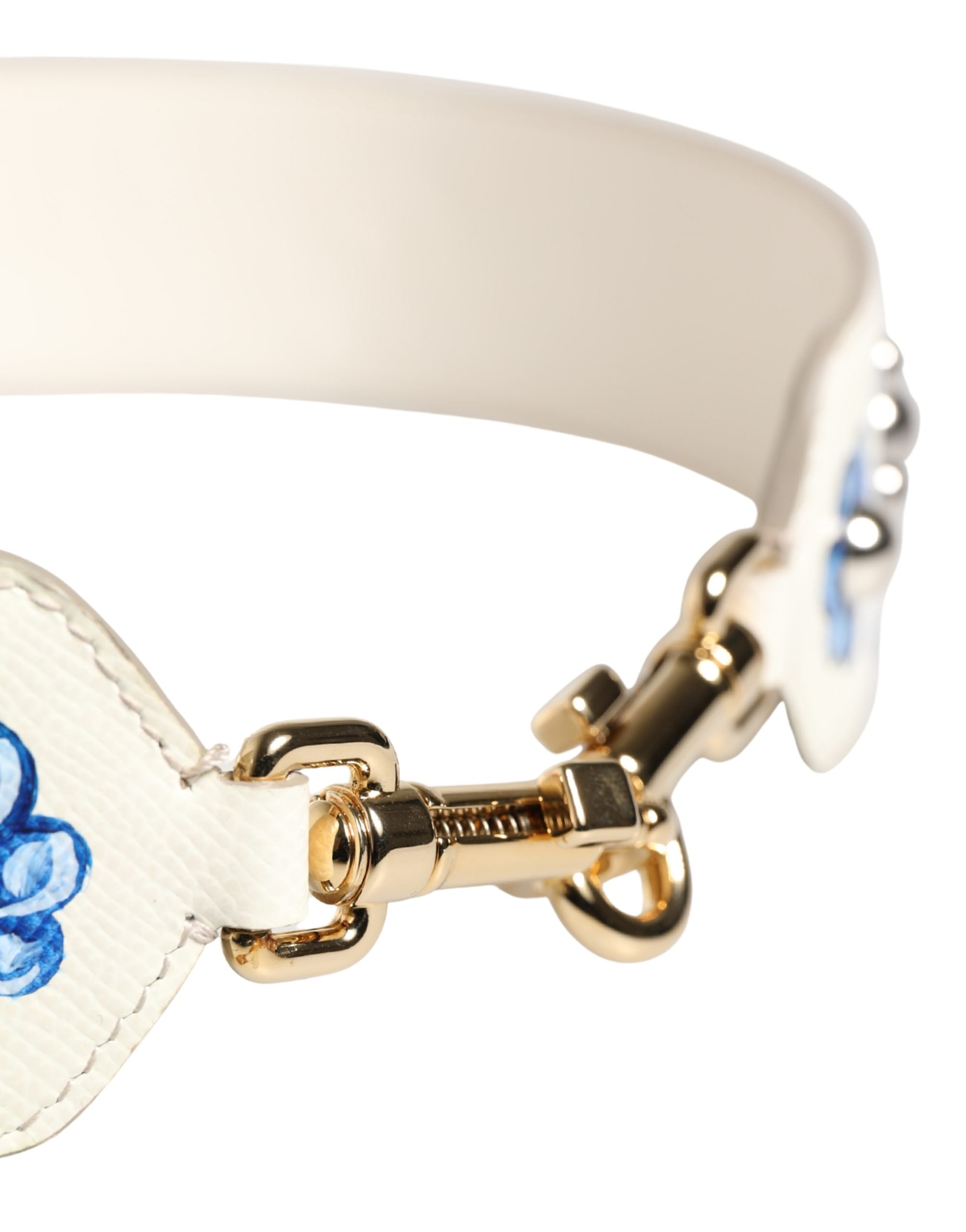 Sangle d'épaule en cuir Dolce & Gabbana blanche et bleue à fleurs avec clous, accessoire de mode élégant et coloré.