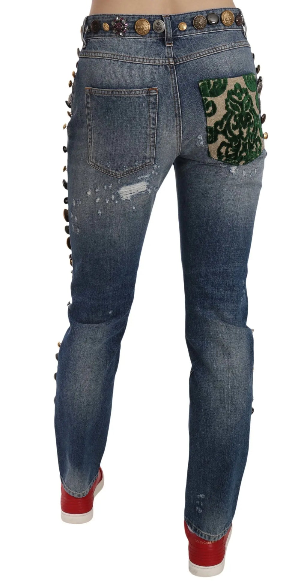 Jean bleu en denim dolce & gabbana avec détails déchirés, boutons dorés décoratifs et patch vert à l’arrière