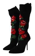 Chaussettes extensibles noires Dolce & Gabbana avec motifs de roses rouges, portées avec des bottines élégantes.